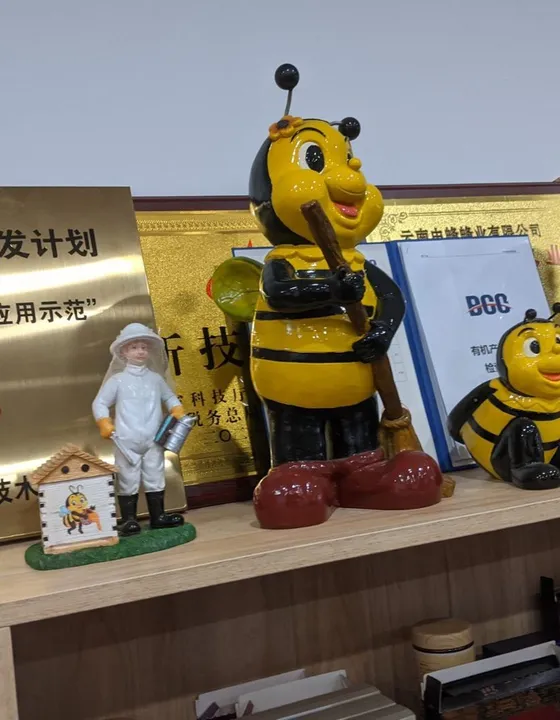 Bee mascot figures and awards on display during the seminar visit in China