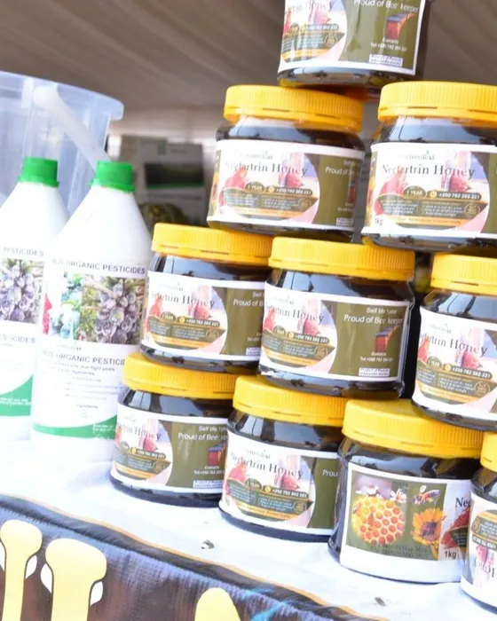 Stacked jars of Nectartrin Honey and bottles of HINGA WEZE on an exhibition table